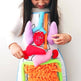 Child holding a colorful anatomical model of the human body