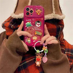 Caso protector de iPhone de silicona con temas de Navidad con chicas colgantes