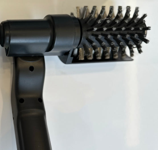 Black hair dryer brush attachment on a white background
