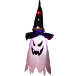 Halloween-themed decoration with ghost face and witch hat on a white background