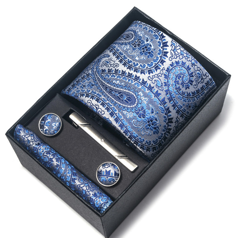Blue paisley tie set with tie clip and cufflinks in a black box on a white background
