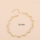 Gold necklace with measurements and weight on a beige background