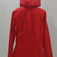 A bright red hooded puffer jacket displayed on a dress form mannequin against a plain light gray wall.