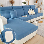 Blue sectional sofa with a close-up of a cushion in a living room setting.
