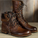 Pair of brown leather boots with lace-up design on a wooden surface.