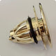 Gold-colored mechanical component on a white background