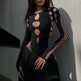 Black outfit with cut-out design on a plain background