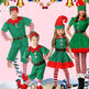 Family in Christmas elf costumes on a festive background with ornaments.