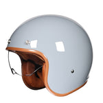 Gray helmet with brown leather chin strap on a white background