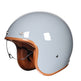 Gray helmet with brown leather chin strap on a white background