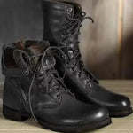 Pair of black leather boots with laces on a wooden surface. Men's & Women's Lace-Up Combat Boots | Mid-Calf Knight Boots & Black