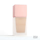 Foundation bottle with pink cap on a white background