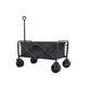 A black folding utility wagon with a canvas side panel, four rugged wheels, and a tall handle, shown on a plain white background.