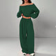 Green off-shoulder top and wide-leg pants set on a gray background