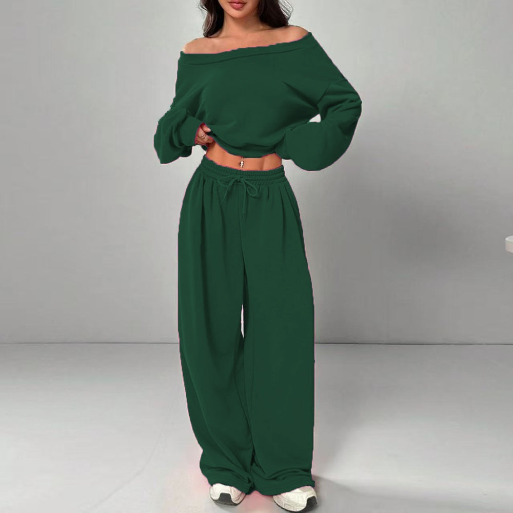 Green off-shoulder top and wide-leg pants set on a gray background