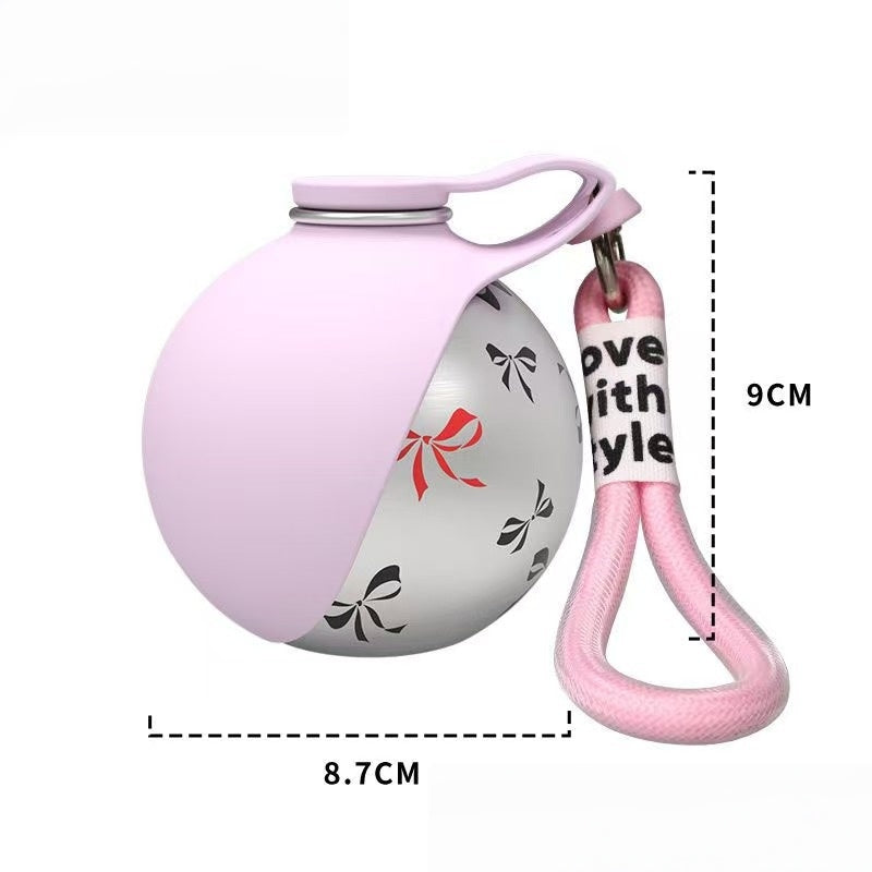 Pink ball-shaped product with a keychain and measurements on a white background