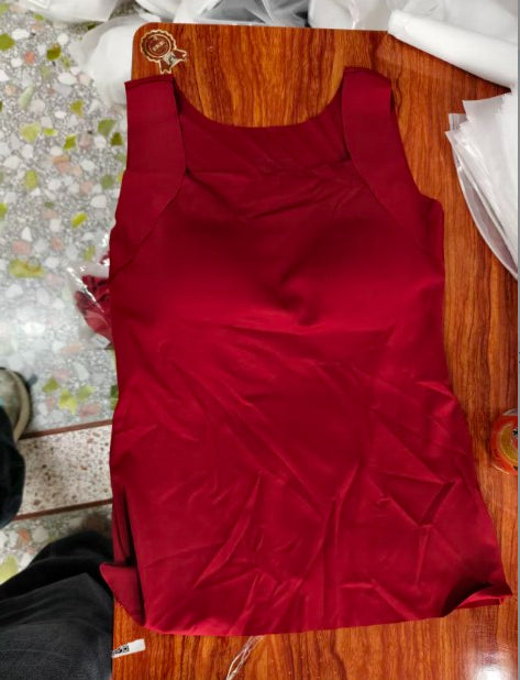 Red dress on a wooden hanger with a floral-patterned floor in the background