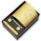 Gold tie set with cufflinks and tie clip in a black box on a white background
