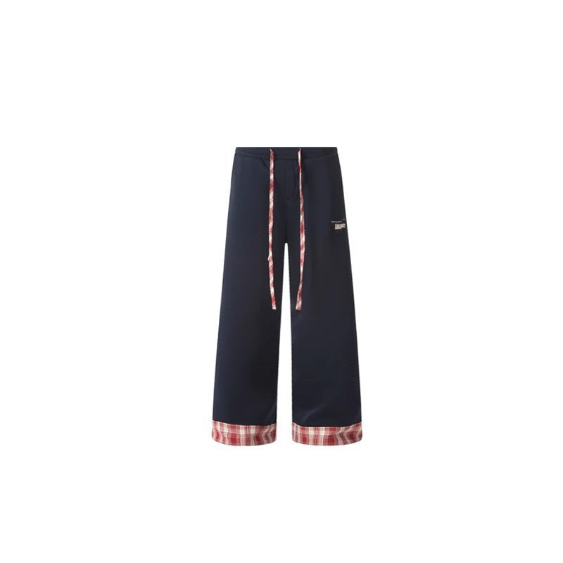 Navy blue pants with plaid cuffs on a white background