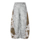 Gray sweatpants with leopard print side panels on a white background