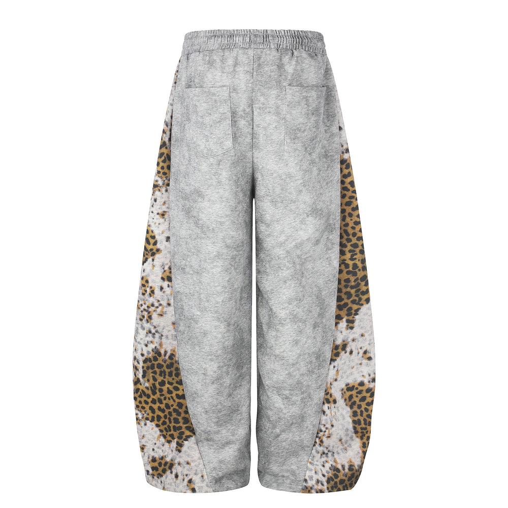 Gray sweatpants with leopard print side panels on a white background