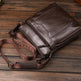 Brown leather bag with visible brand name on a wooden surface