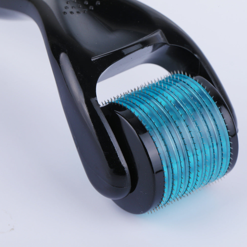 Close-up of a black and teal roller device on a light gray background