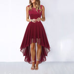 Woman wearing a burgundy lace dress with a white background