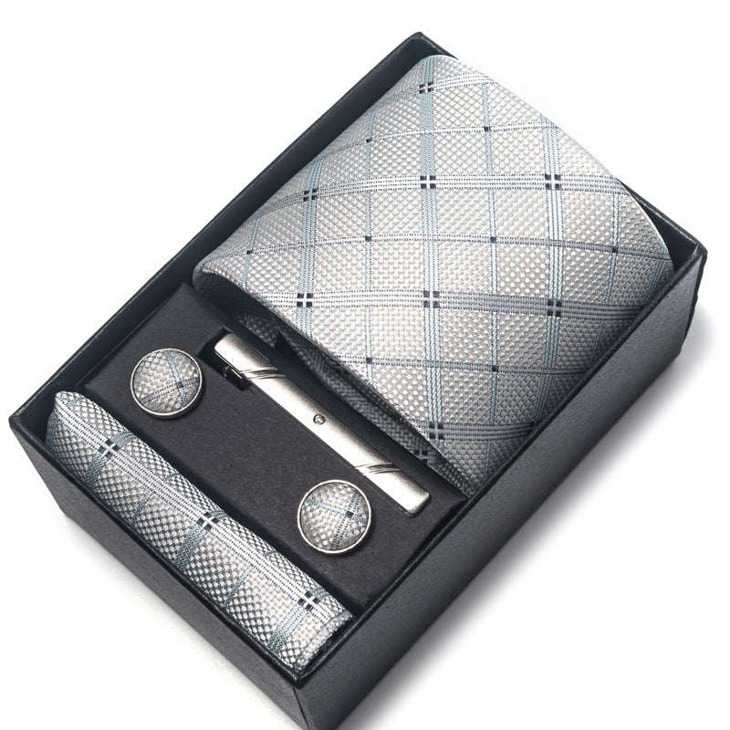 Men's accessory set with tie, cufflinks, and pocket square in a black box on a white background