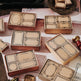 Collection of vintage-style card boxes with decorative labels on a textured surface.