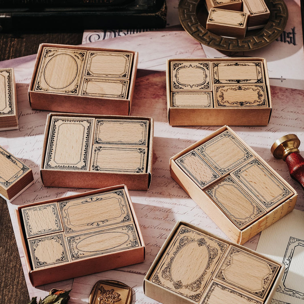 Collection of vintage-style card boxes with decorative labels on a textured surface.