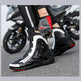Motorcycle boots and gloves on a blurred motorcycle background
