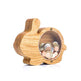 Wooden piggy bank with coins inside on a white background