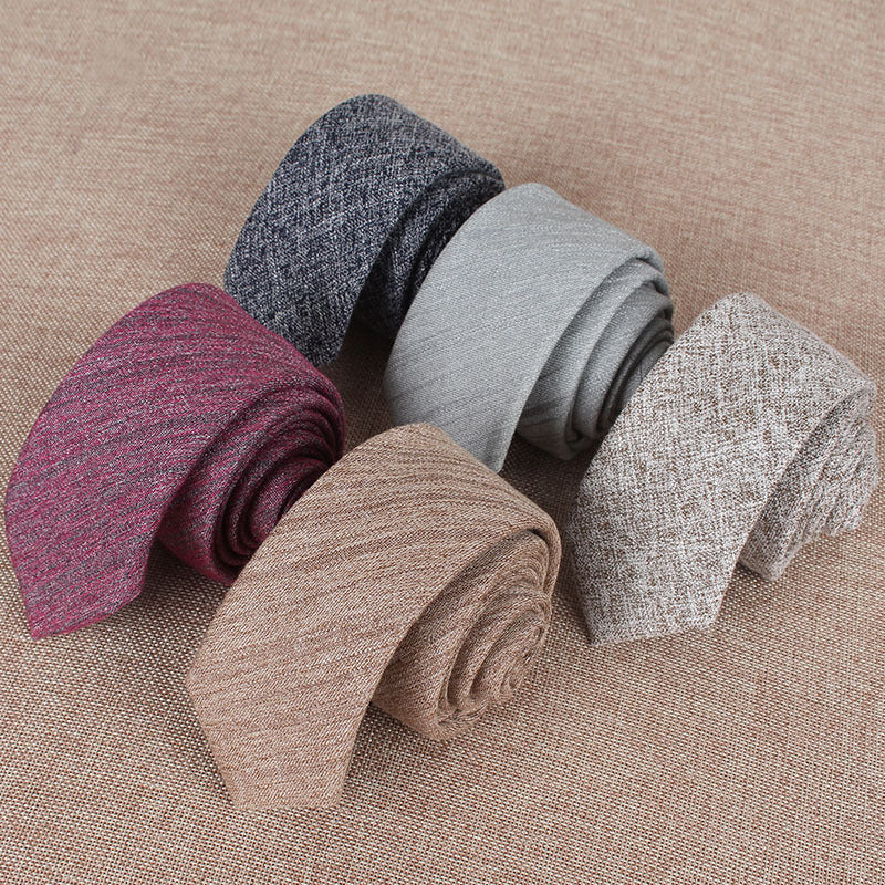 Set of rolled-up socks in various colors on a textured surface