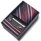 Striped tie, tie clip, and cufflinks set in a black box on a white background