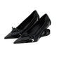 Black pointed-toe shoes with bow details on a white background