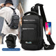 Black backpack with multiple compartments and a phone case, worn by a person.