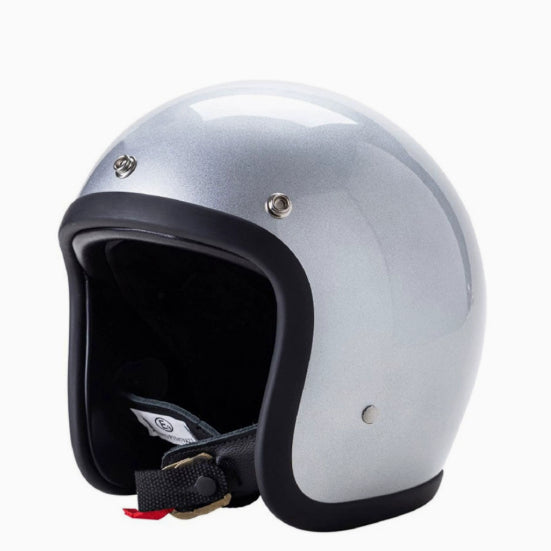 A silver metallic open-face motorcycle helmet with a black visor trim and interior padding, shown on a plain white background.