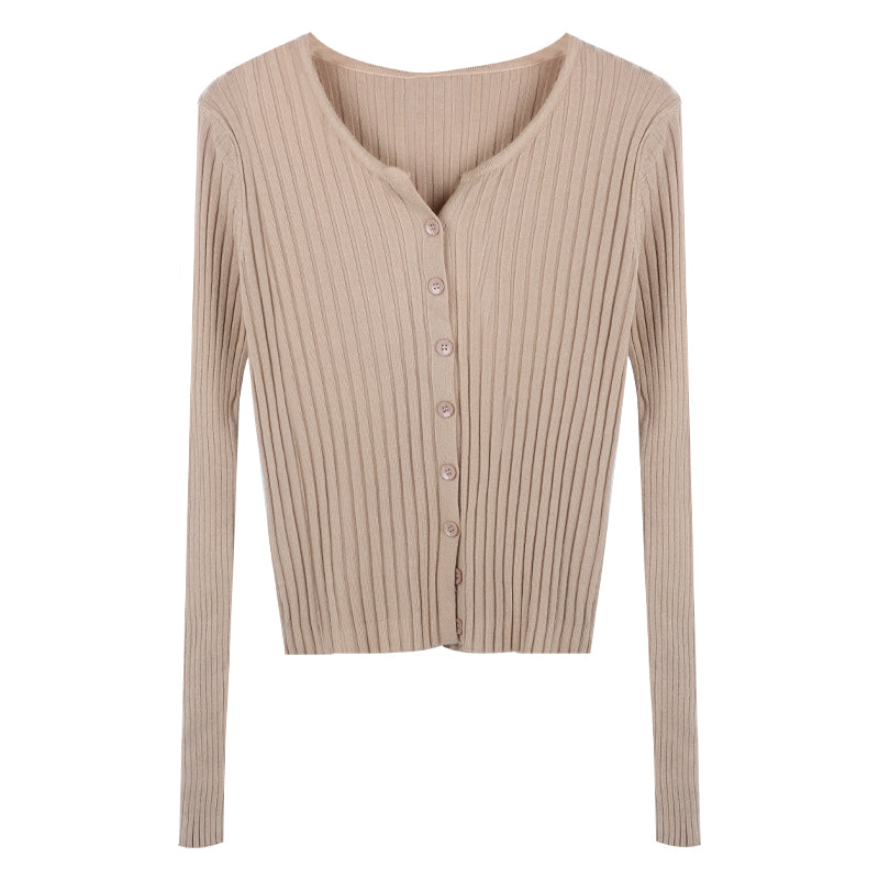 Beige ribbed sweater with buttons on a white background