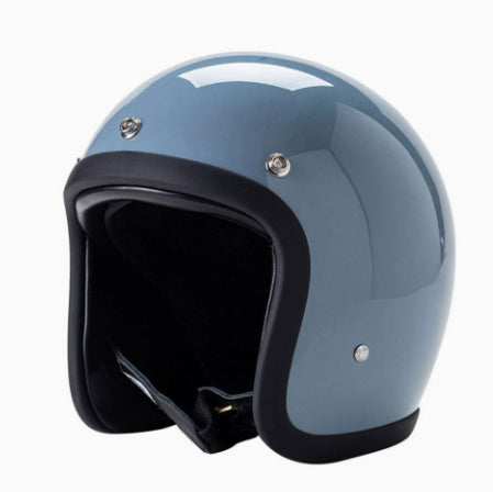 A glossy light blue open-face motorcycle helmet with black trim and a black interior, shown on a plain white background.