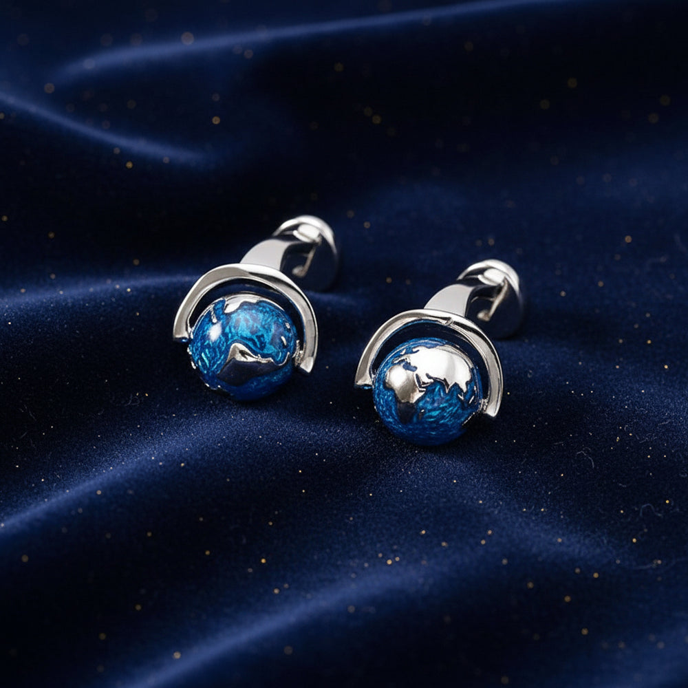 Silver cufflinks with blue stone on a white background