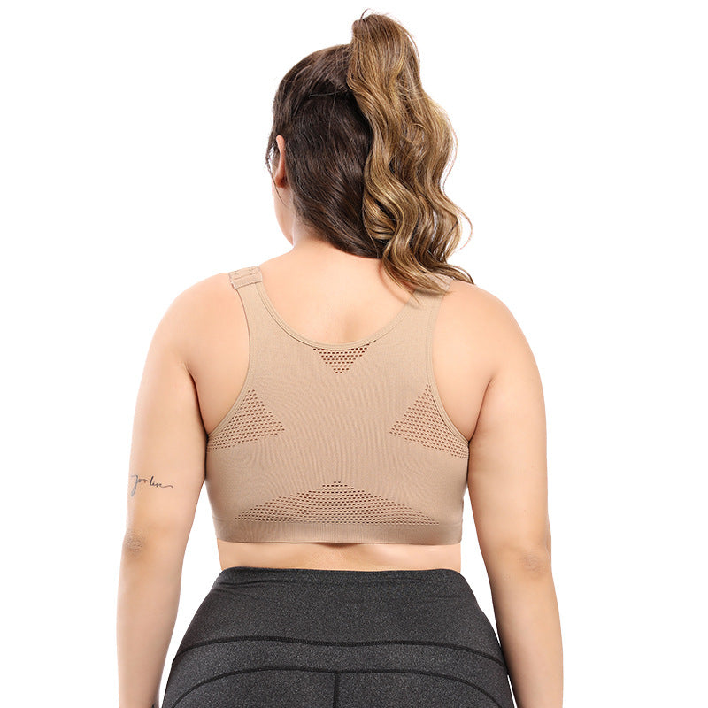 Woman wearing a beige sports bra and gray leggings on a white background