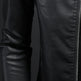 Close-up of a black leather jacket with a zipper on a dark background
