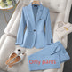 Light blue suit with pants, shoes, and handbag on a gray sofa.