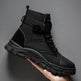 Black tactical boot held by a hand against a gray background