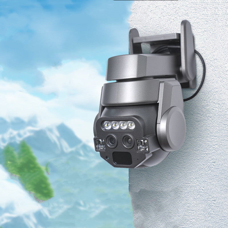 Security camera mounted on a wall with a scenic background of mountains and water.