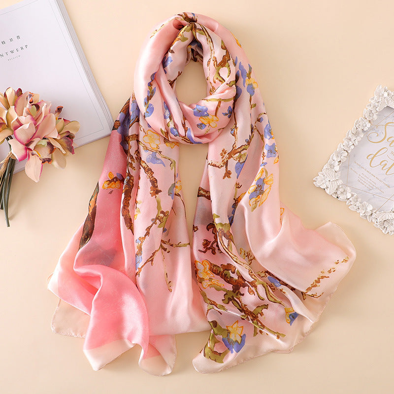Pink floral scarf on a beige surface with decorative elements