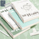 Notebooks with 'Be Happy' and motivational text on a green background