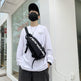 Person wearing a white sweatshirt with a black backpack in front of a store.