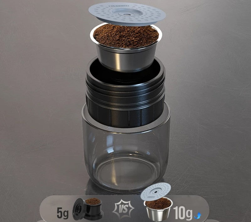 Coffee brewing device with a clear container and metal filter on a gray background